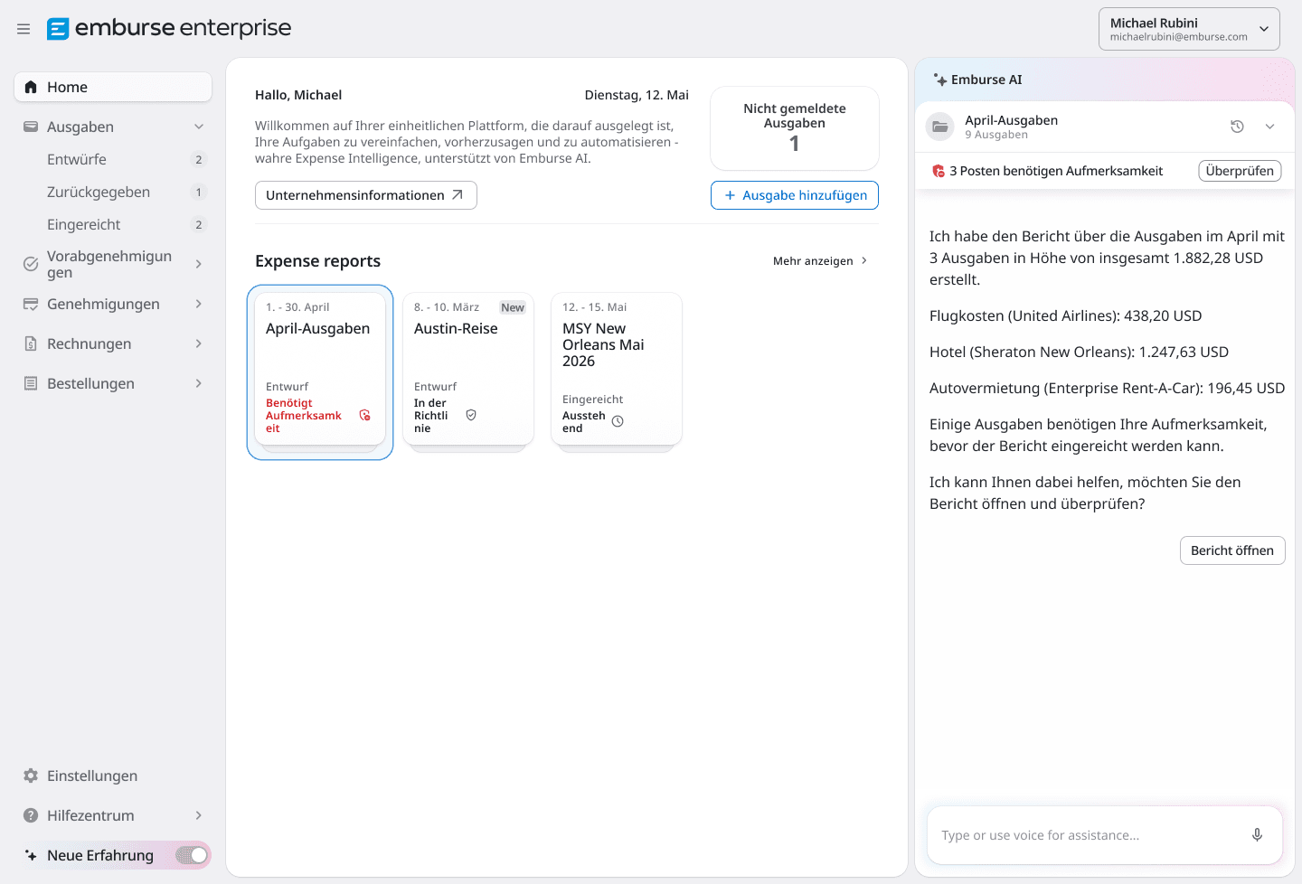 A desktop monitor displays the Emburse Enterprise expense management software, showing expense reports and an AI assistant detailing a trip expense report.