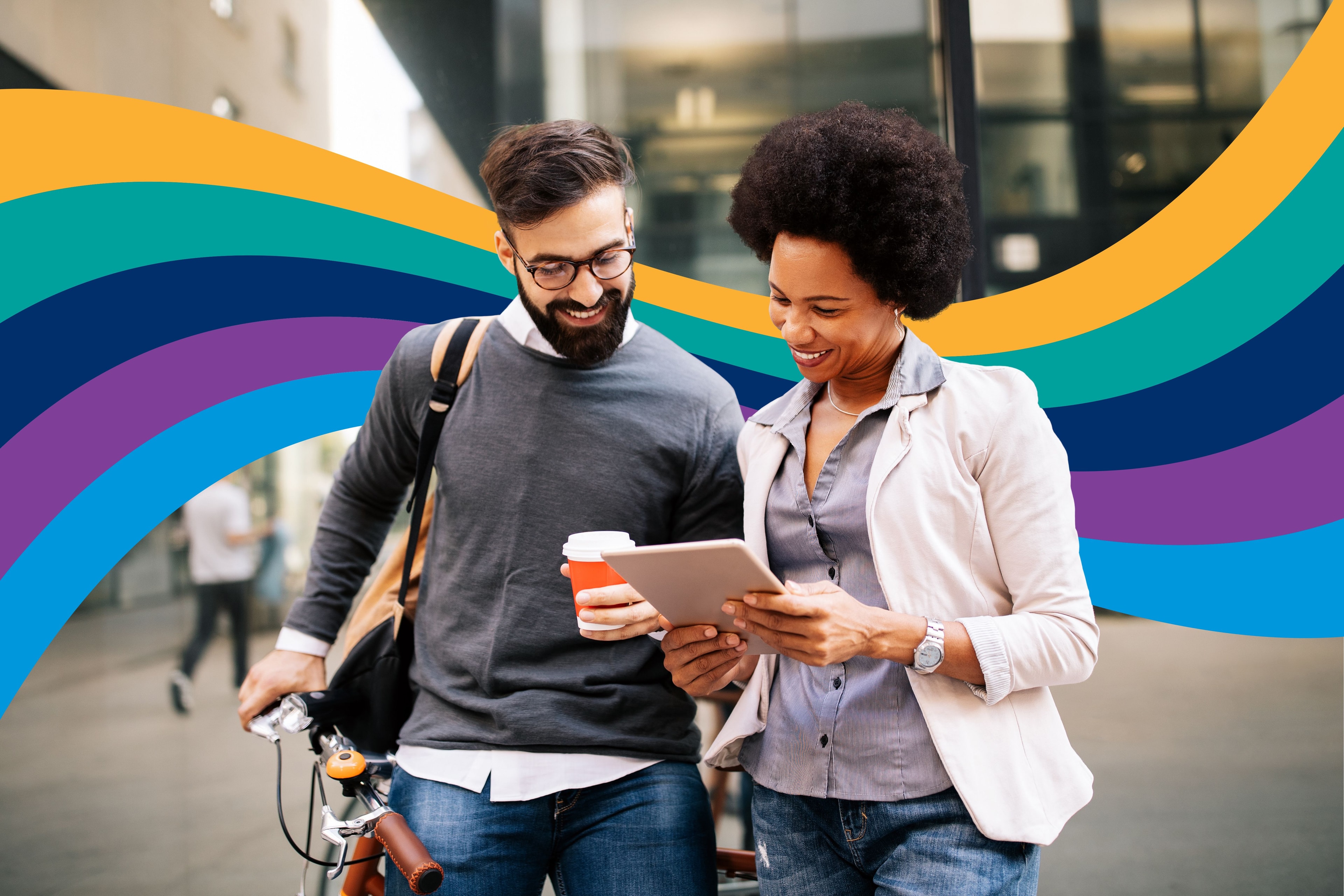 a man and a woman are looking at a tablet together .