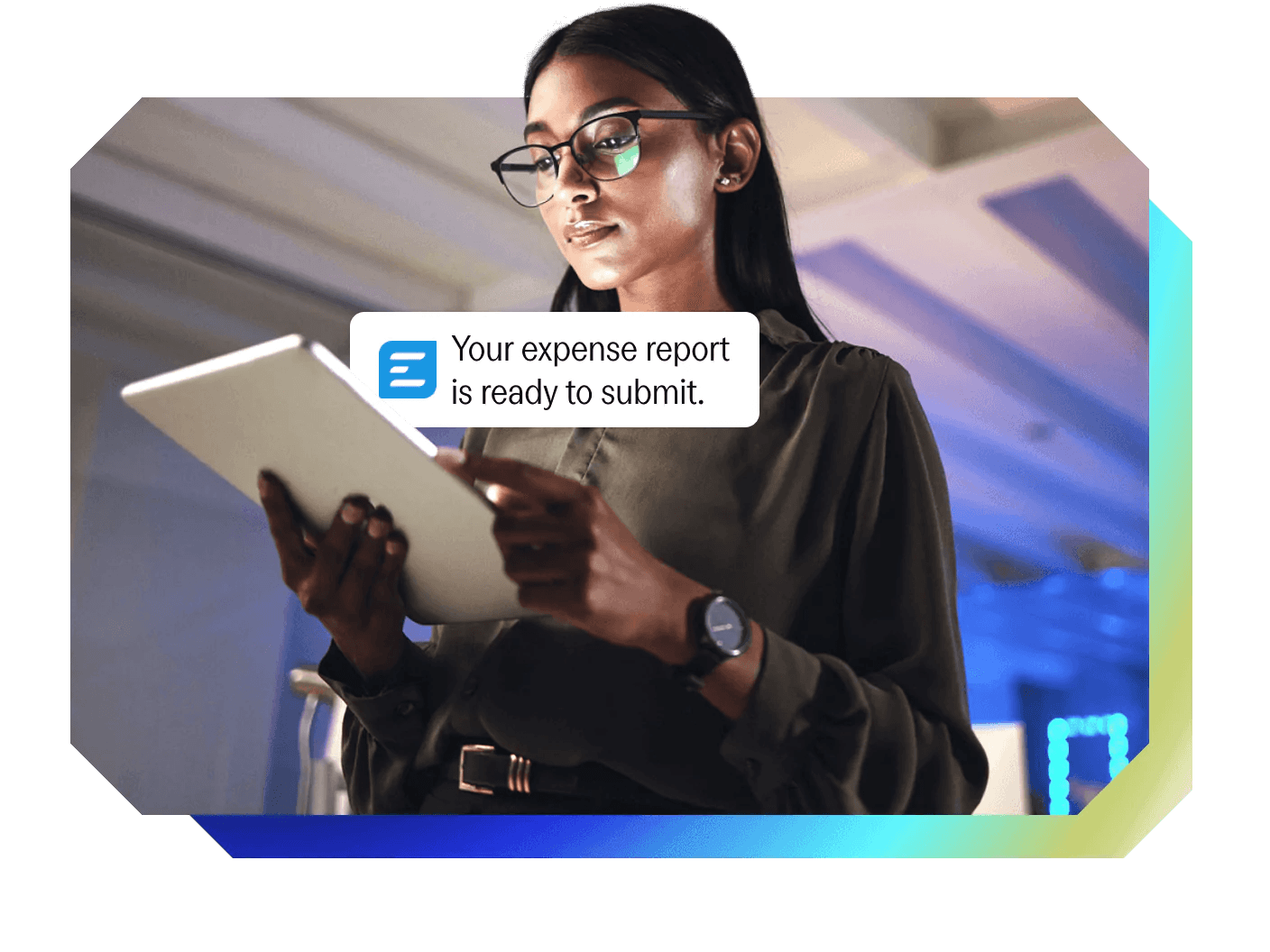a woman holding a tablet with a notification that says your expense report is ready to submit