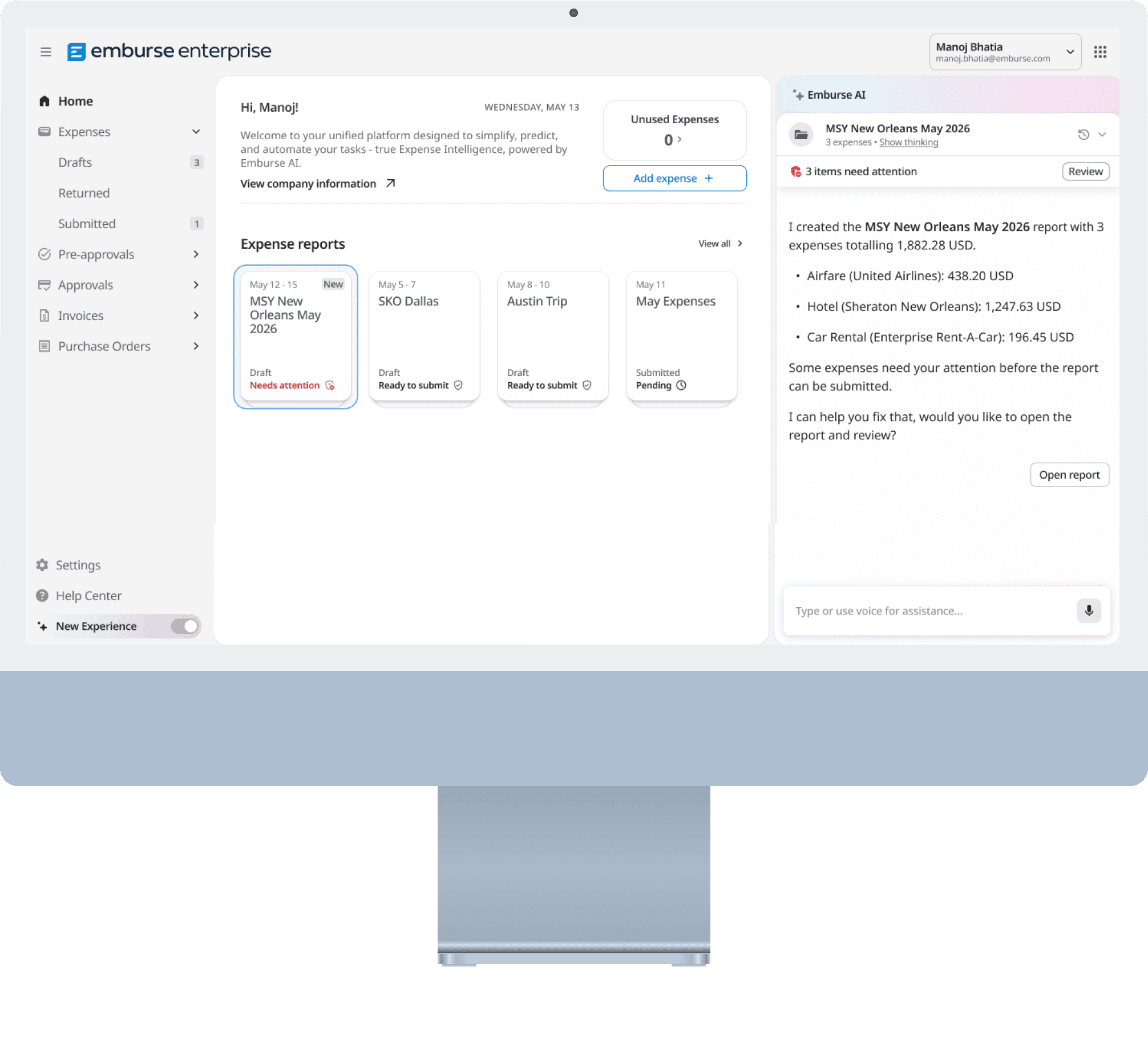 A computer monitor displaying the Emburse Enterprise expense management dashboard with an AI assistant summarizing trip expenses.