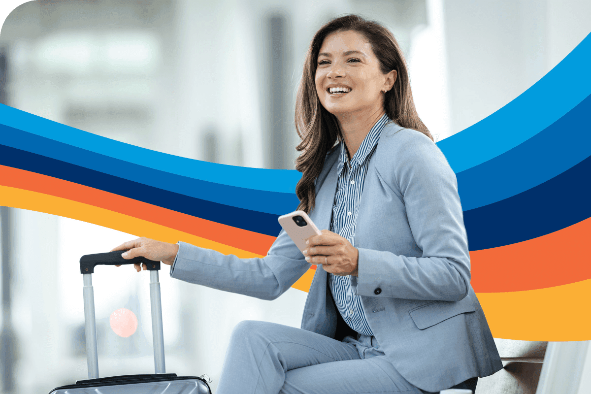 a woman in a suit is smiling while holding a cell phone