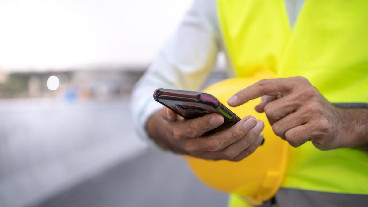 Construction worker using a smartphone