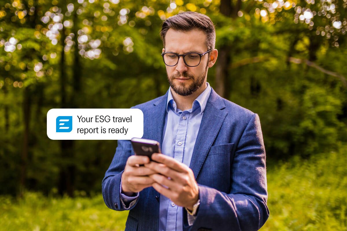 a man in a suit and tie is looking at his cell phone