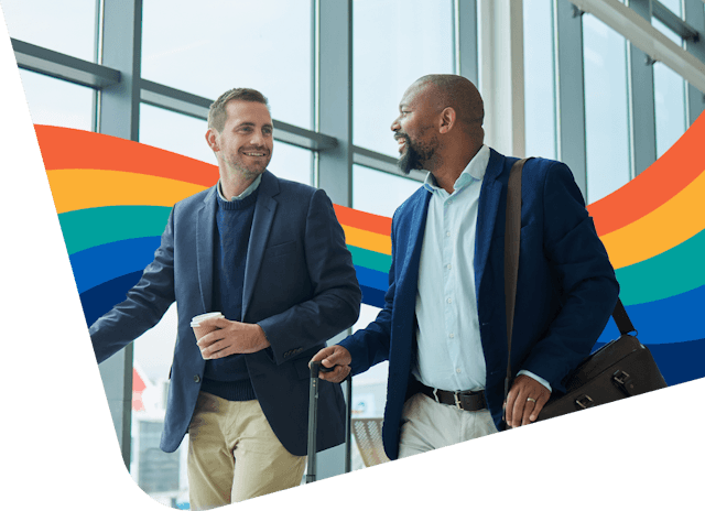 dos hombres están de pie frente a una ventana con un arcoíris de fondo