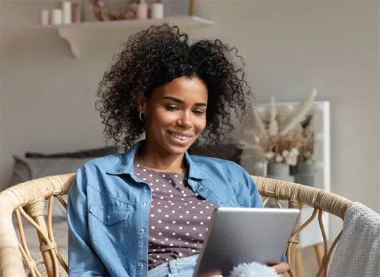 Happy person using Emburse Certify on tablet