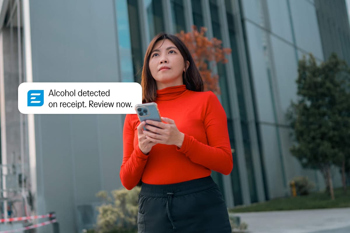 A woman holding a phone displays a notification: "Alcohol detected on receipt. Review now."